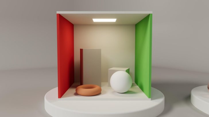 A 3D-rendered Cornell box features a white sphere, an orange torus, a gray rectangular block, and a cube with red and green walls, under a ceiling light.